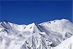 Off piste snowy slope and blue clear sky. Caucasus Mountains, Georgia, ski resort Gudauri.