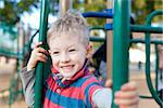 cheerful positive kid spending fun time at the playground