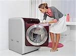 Housework, young woman doing laundry