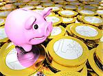 Happy pink piggy bank on pile of Euro coins, concept of savings and wealth