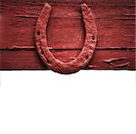 The old horseshoe hanging on wooden wall on a white background