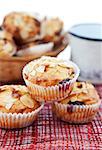 Almonds and cherries muffins with cup of milk on the background