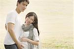 Happy young Asian pregnant couples at outdoor nature.