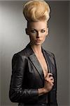 cool portrait of charming blond girl with fashion rock style, creative hairdo and leather jacket