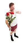 Scruffy looking guy in his underwear with too much confidence holding a vase of red roses and pointing at you. Full body isolated on white.