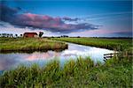 little farmhouse and river at colorful sunset, Groningen, Netherlands