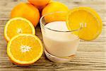 fresh tropical orange yoghurt shake dessert on wooden background