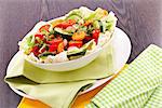 fresh mixed colorful salad on wooden table with green and yellow decoration