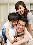 loving asian family having fun at home.