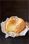 French cheese Langres on an old wooden background.