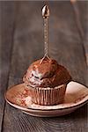 Delicious chocolate muffin with spoon close-up.