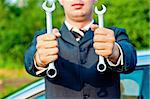 spanners in the hands of a businessman