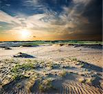 Cloudy sky and sunlight over sandy desert