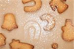 Various gingerbread cookies on cooking paper background