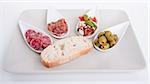 deliscious antipasti plate with parma parmesan and olives isolated on white background