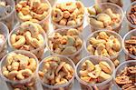 Roasted cashew nuts snack in plastic cups at market stall