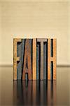 The word FAITH written in vintage letterpress type