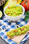 Delicious guacamole with avocado, lime and tomato