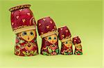 Red russian wooden nesting dolls wearing their bottom as a hat
