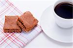 sweet cookies biscuit with black coffee on wooden table