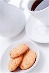 dark coffee in white cup and homemade cookie on table