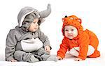 Two baby boys dressed in animal costumes over white