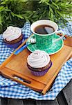 Cupcake and cup of coffee on the tray