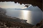 Family rock climber against picturesque view of Telendos Island at sunset. Kalymnos Island, Greece.