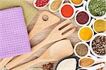 Various spices selection and kitchen utensils on wooden table