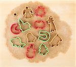 Gingerbread dough for christmas cookies with colorful cookie cutters