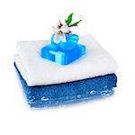 White and blue towels. Blue natural soap and almond flower.