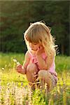 a beautiful little girl playing in nature