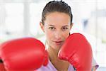 Closeup portrait of a determined female boxer in the gym