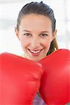 Closeup portrait of a smiling female boxer in the gym