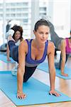 Young women doing stretching exercises in the fitness studio