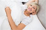 High angle portrait of a pretty mature woman resting in bed