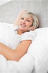 Portrait of a pretty mature woman resting in bed
