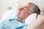 Closeup of senior man sleeping in bed at home