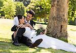 Happy young newlywed couple relaxing in the park