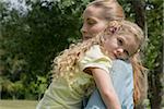 Side view of a mother carrying daughter at the park