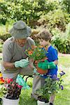 View of a grandfather and grandson engaged in gardening