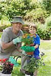 Portrait of a smiling grandfather and grandson engaged in gardening