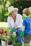 View of a grandmother and grandson engaged in gardening