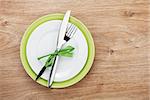 Fork with knife over plates. On wooden table background with copy space