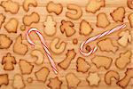 Various gingerbread cookies with candy cane on wooden table background