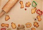 Rolling pin and gingerbread cookies on cooking paper with copy space