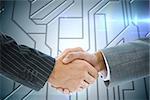 Composite image of business handshake against circuit board on futuristic background