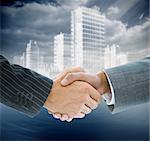 Composite image of business handshake against digital cityscape