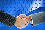 Composite image of business handshake against hexagons on blue background