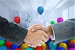 Composite image of business handshake against balloons in a room